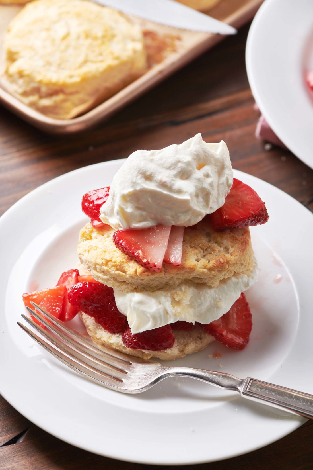 Strawberry Shortcake on a white plate with a fork.