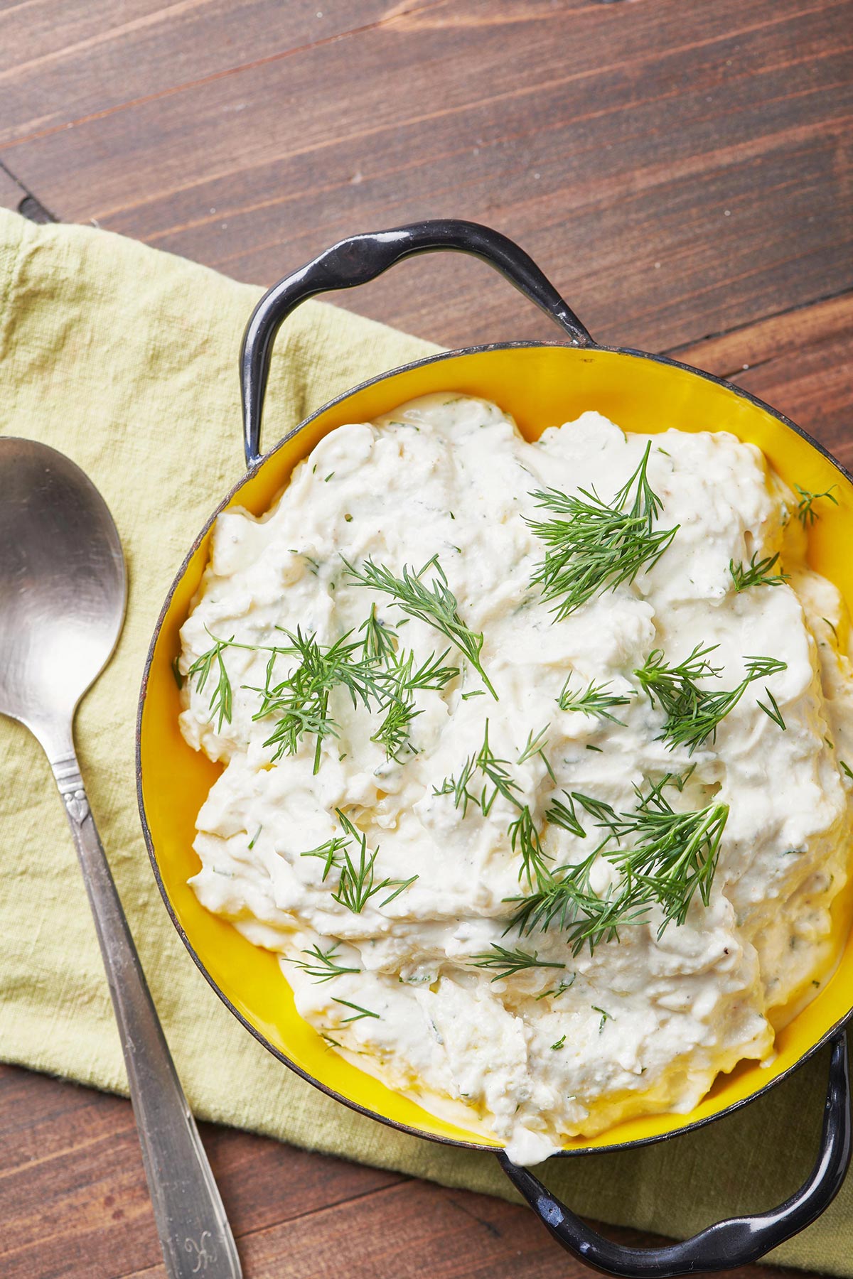 Feta Yogurt Dip in a bowl next to a spoon.