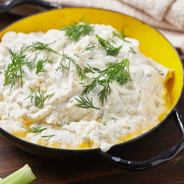 Feta Yogurt Dip with fresh dill in bowl on table.