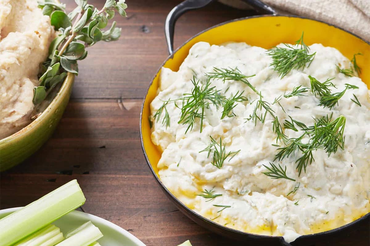Bowl of Feta Yogurt Dip on a wooden table.
