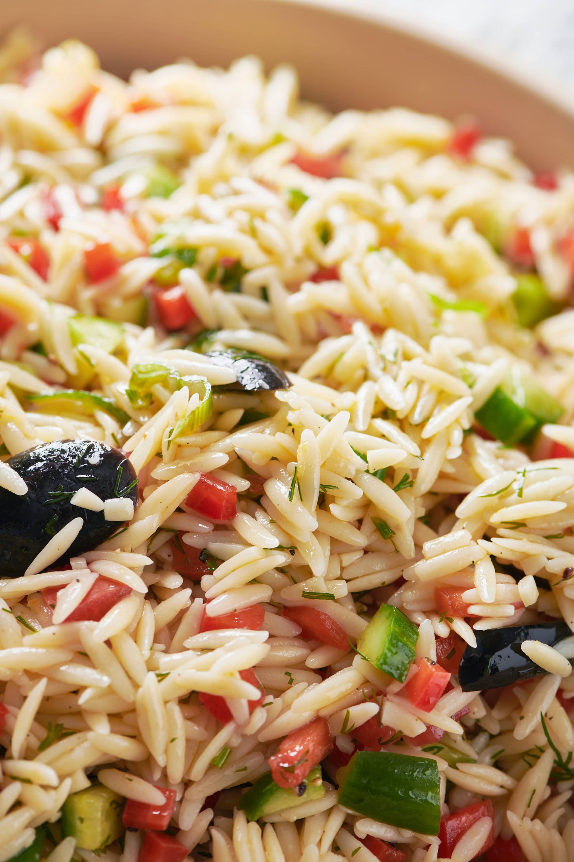 Greek Orzo Salad with olives, cucumbers, and tomatoes.