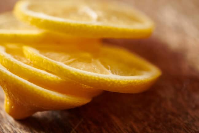 Lemon slices on a wooden surface.