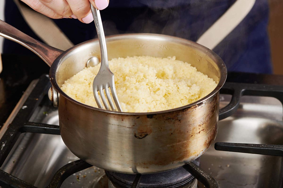 Fork stirring a pan of Couscous.