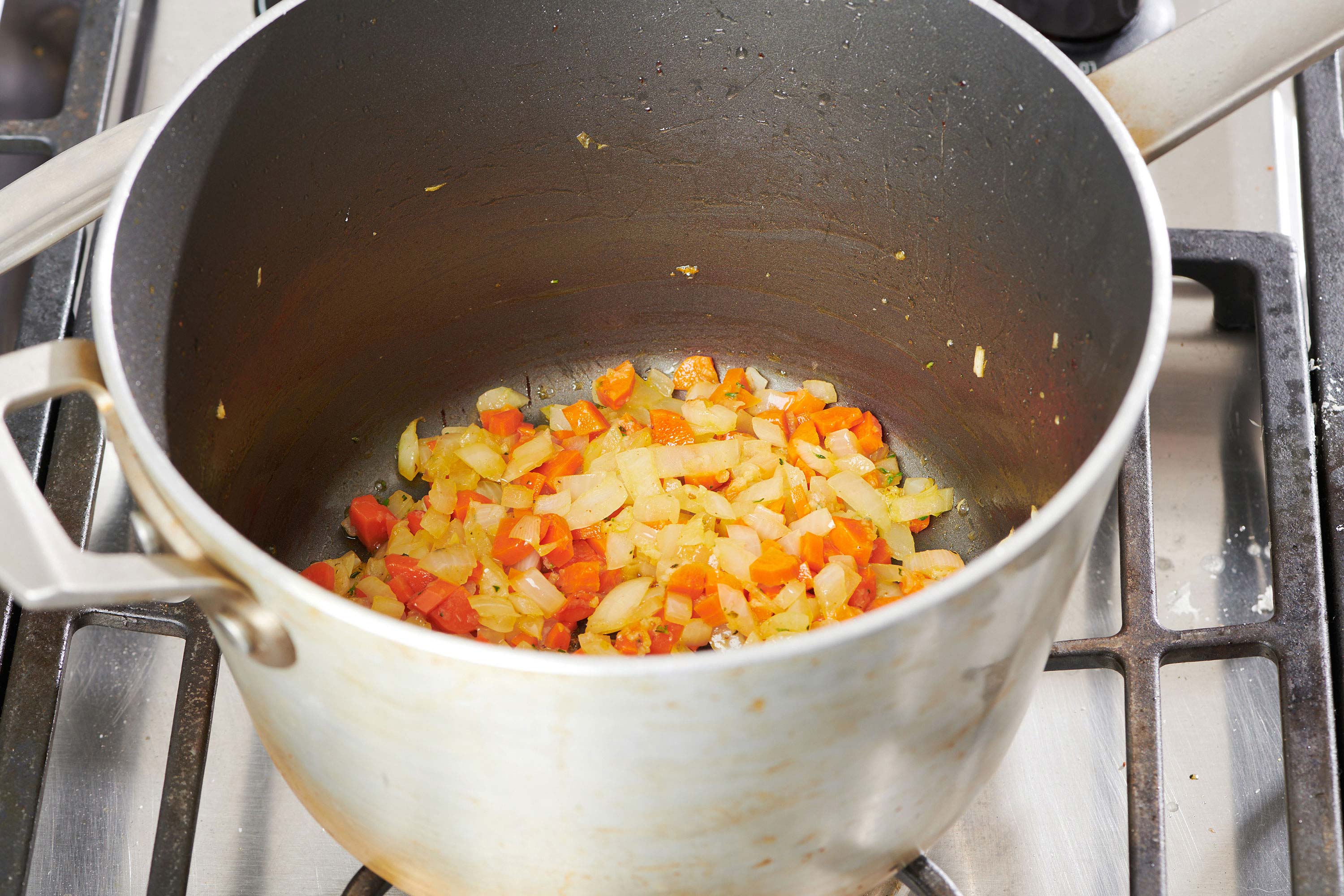 Onions and carrots in a large pot.
