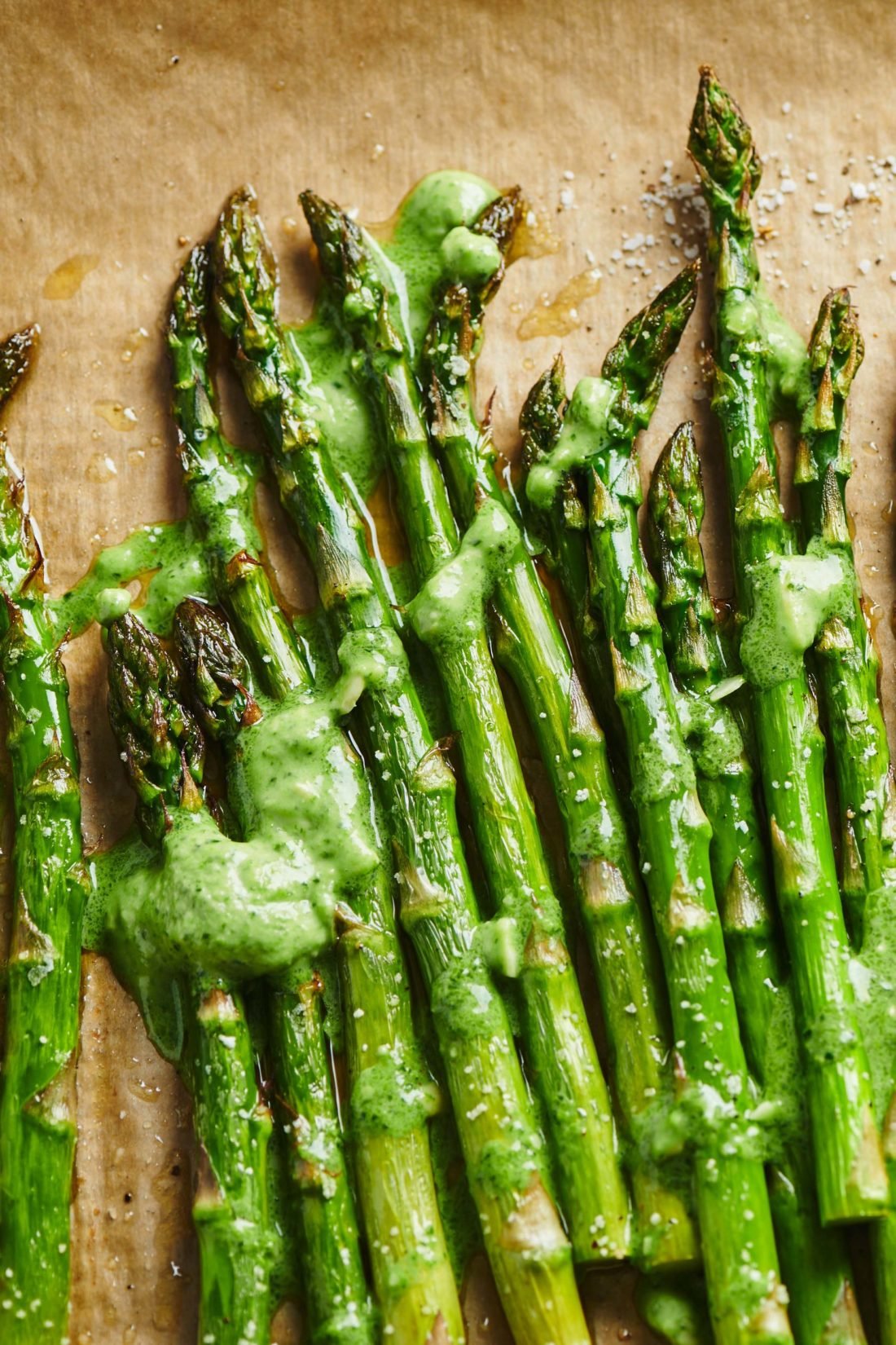 Roasted Asparagus with Pesto Crème Fraiche on parchment paper.