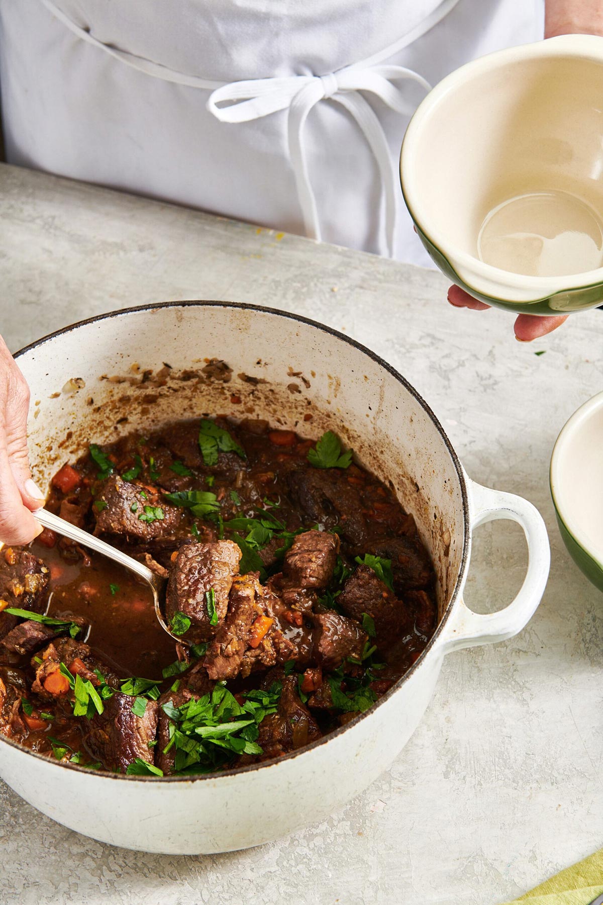 Spoon scooping Beef Stew into a bowl.