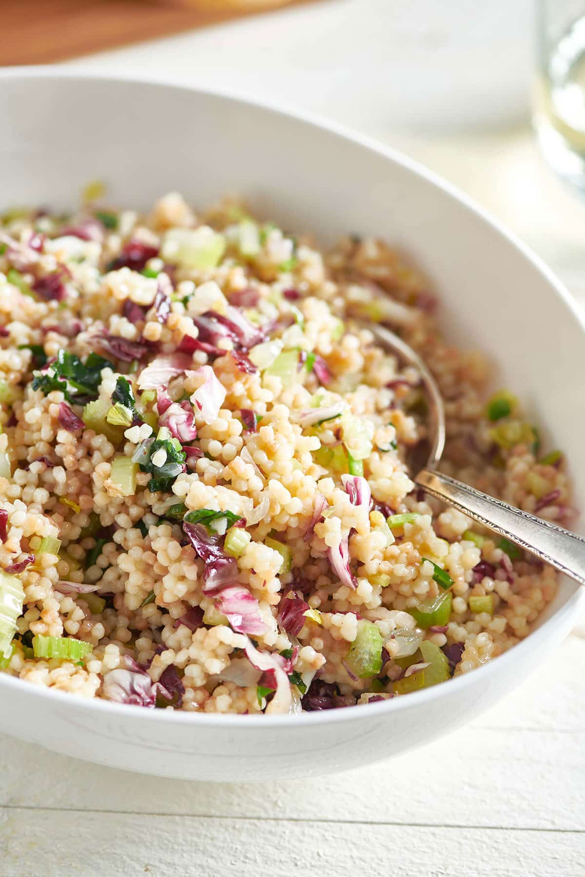 Spoon in a bowl of Couscous Salad.