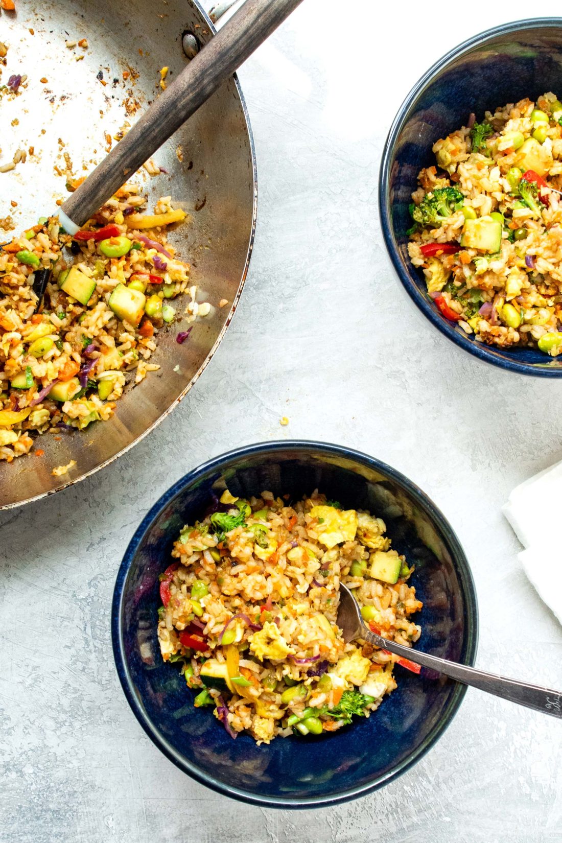 Vegetable Stir Fried Rice in bowls and a wok.