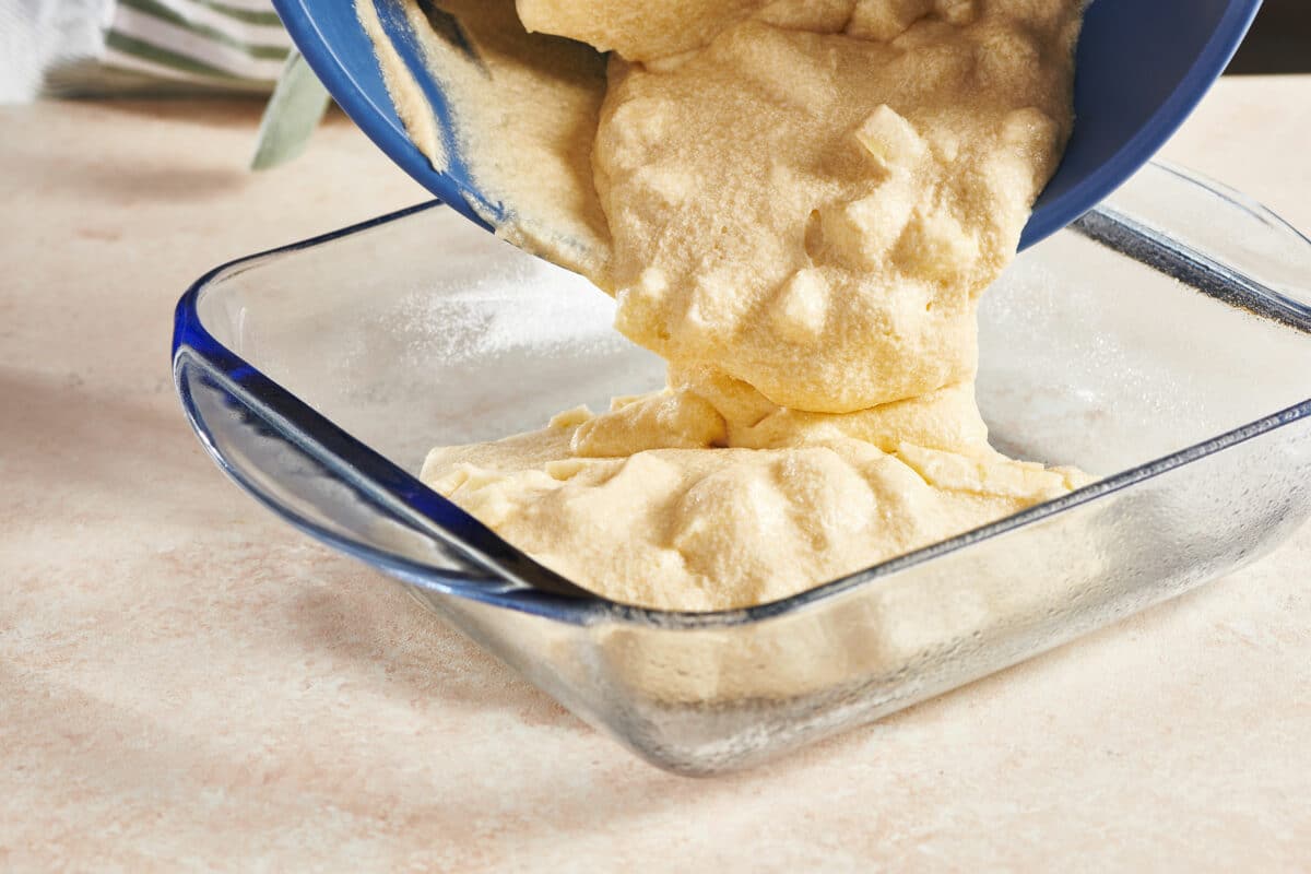 Apple Coffee Cake batter pouring into a baking dish.