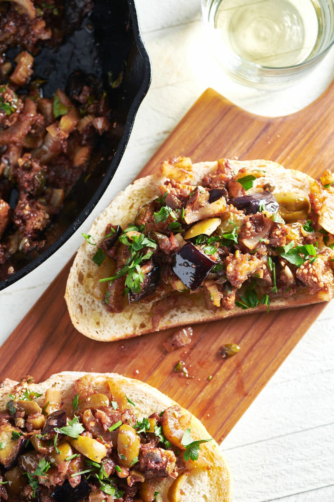 Wooden board of Caponata bruschetta.