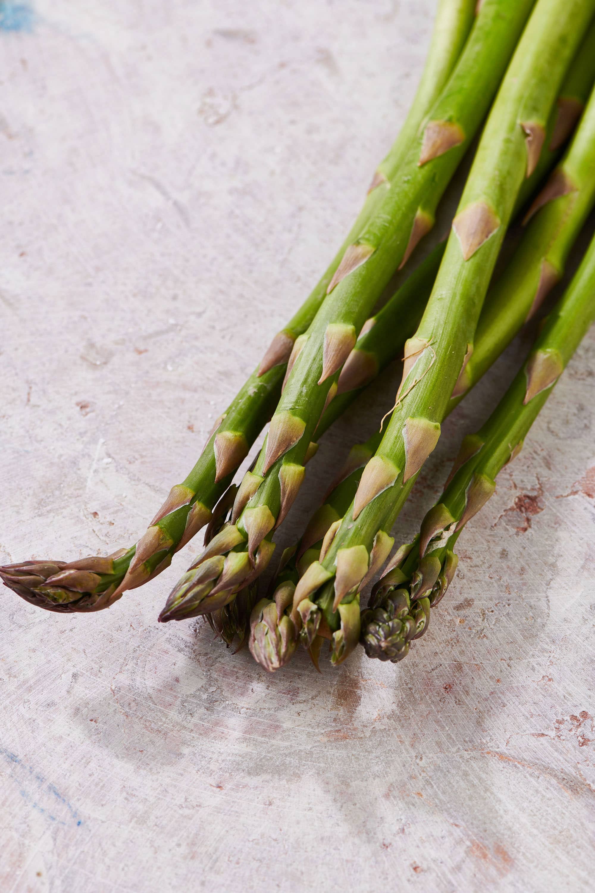 Fresh asparagus spears on table.