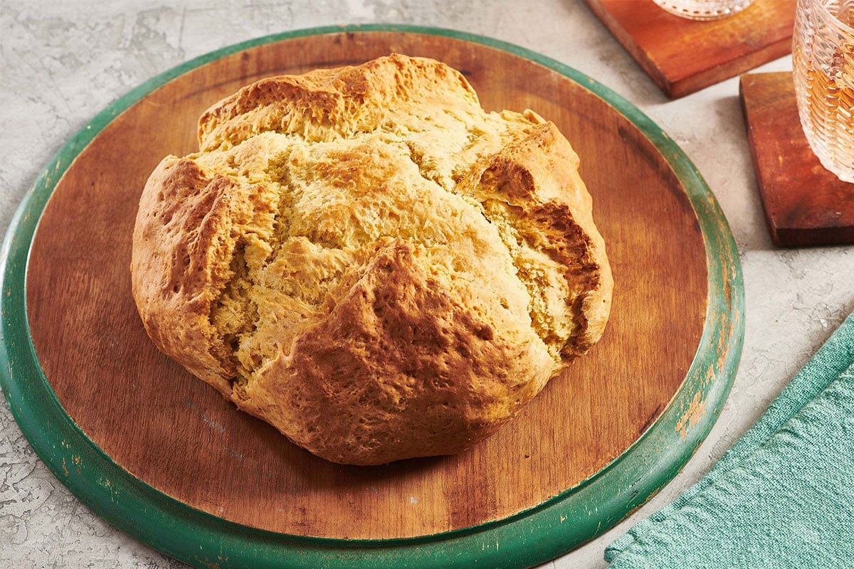 Loaf of Irish Soda Bread on a wooden board.