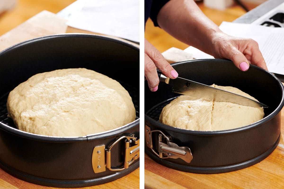 Woman scoring bread dough with a large knife.