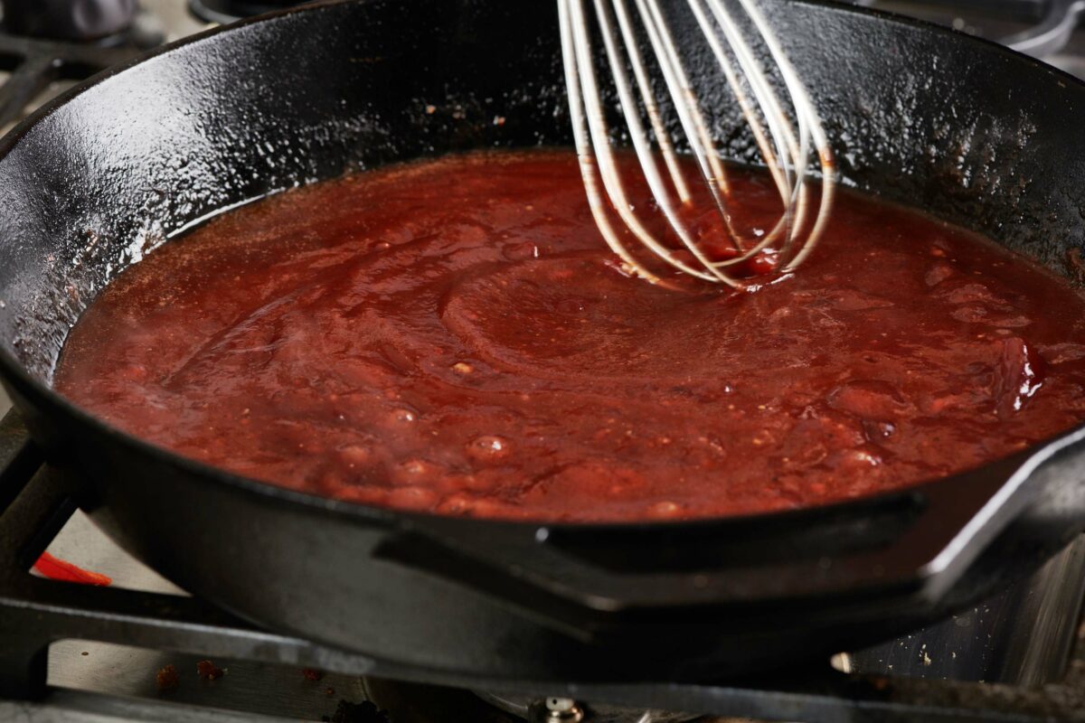 Whisk in a skillet of a ketchup and soy sauce mixture.
