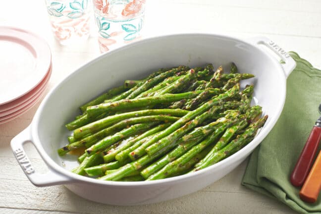 Grilled asparagus in a white, oblong dish.