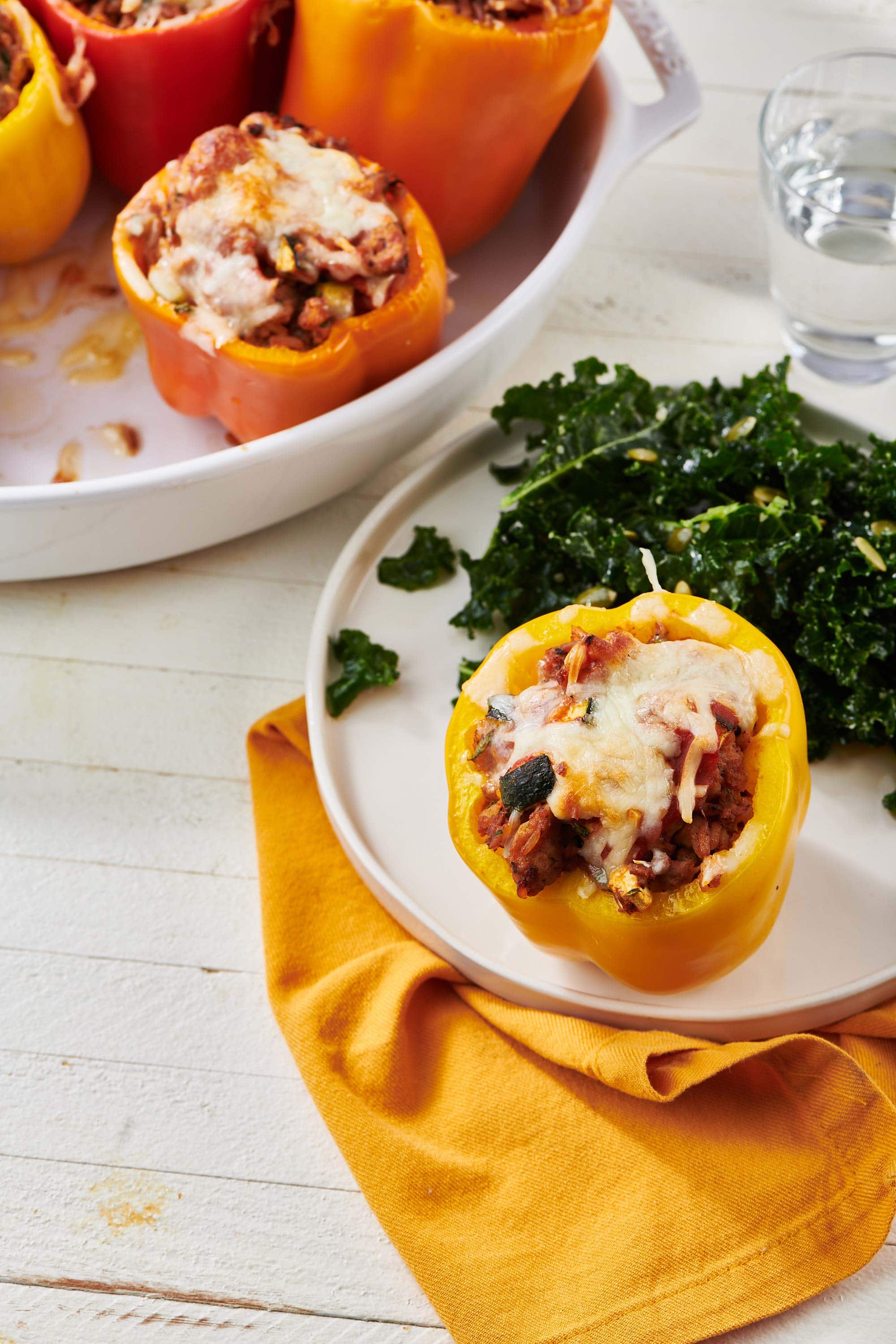 Ground Turkey Stuffed Pepper on a plate with greens.