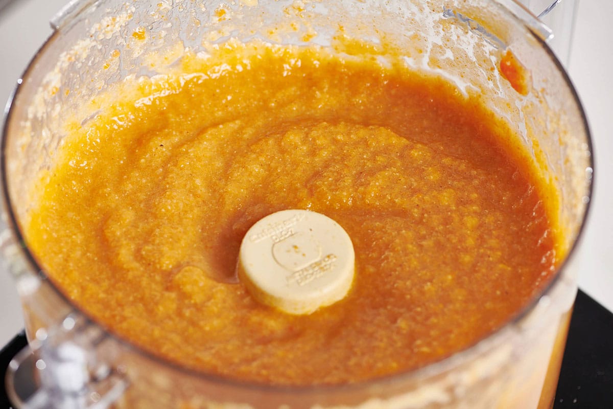 Pureed Moroccan Carrot and Cauliflower Soup in a food processor.