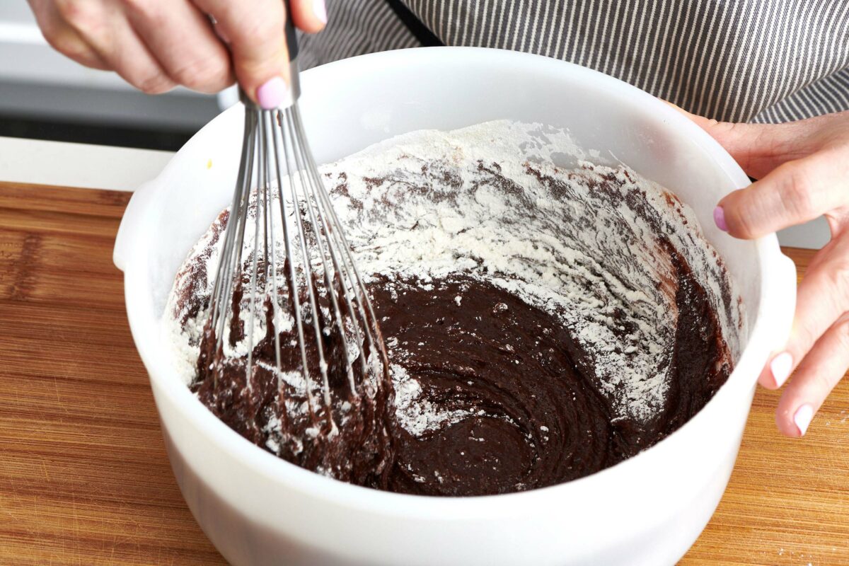 Whisk in a bowl of Fudgy Chocolate Cake ingredients.