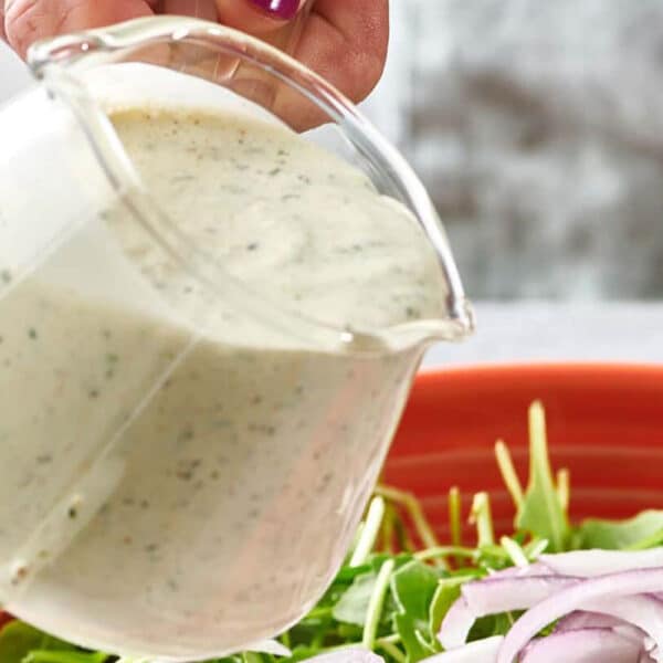 Homemade ranch dressing in small pitcher.