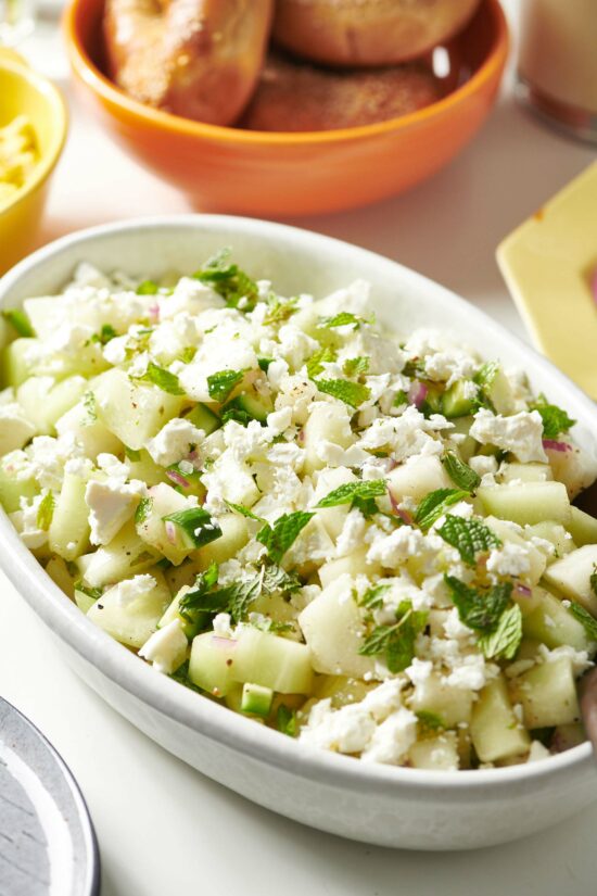Honeydew-Cucumber Salad with Feta in an oblong, white bowl.