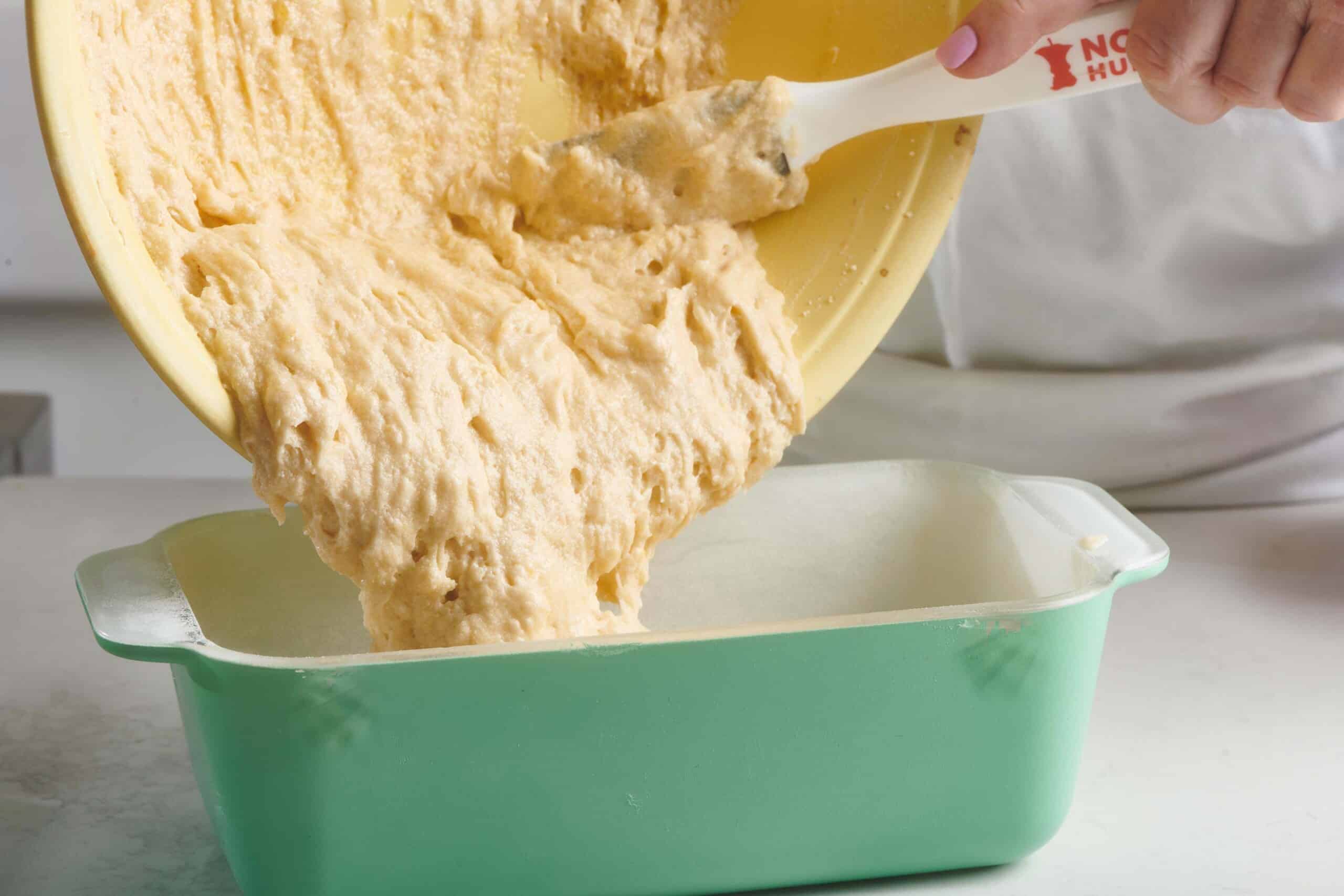 Lemon Cake batter pouring into a pan.