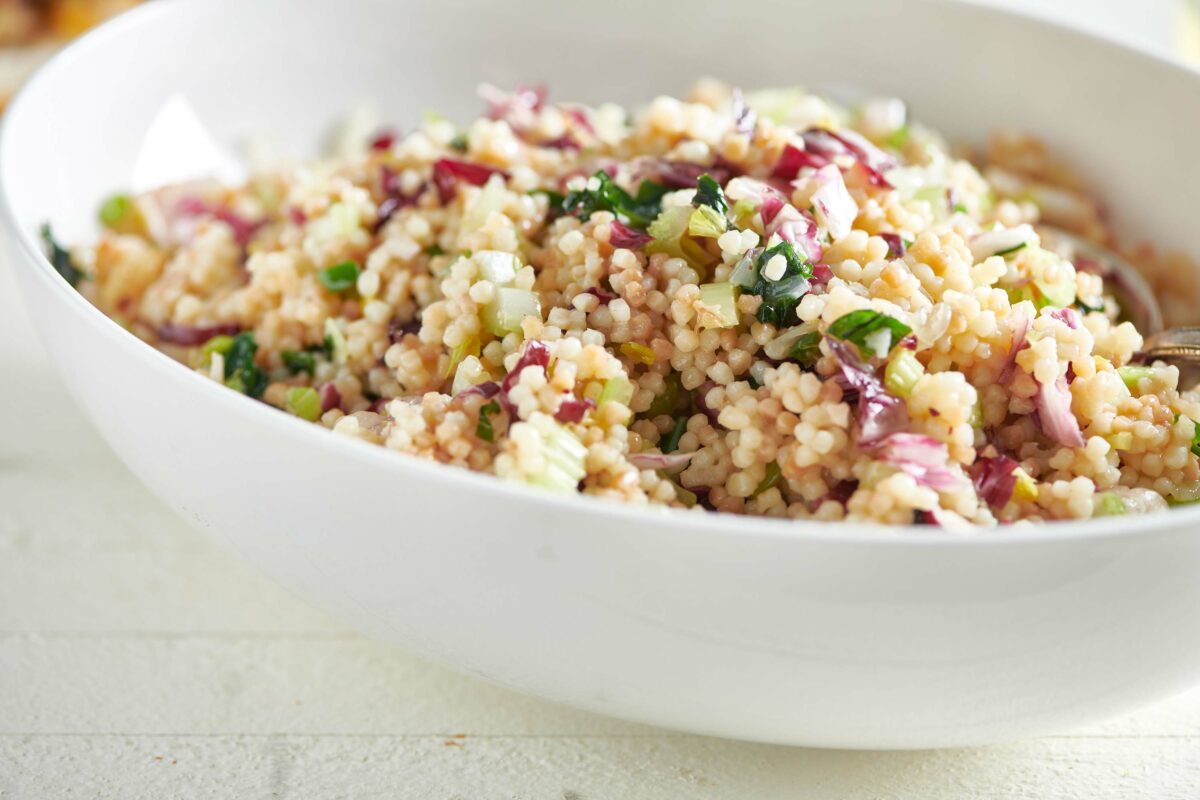 Couscous Salad with ramps and radicchio in a white bowl.