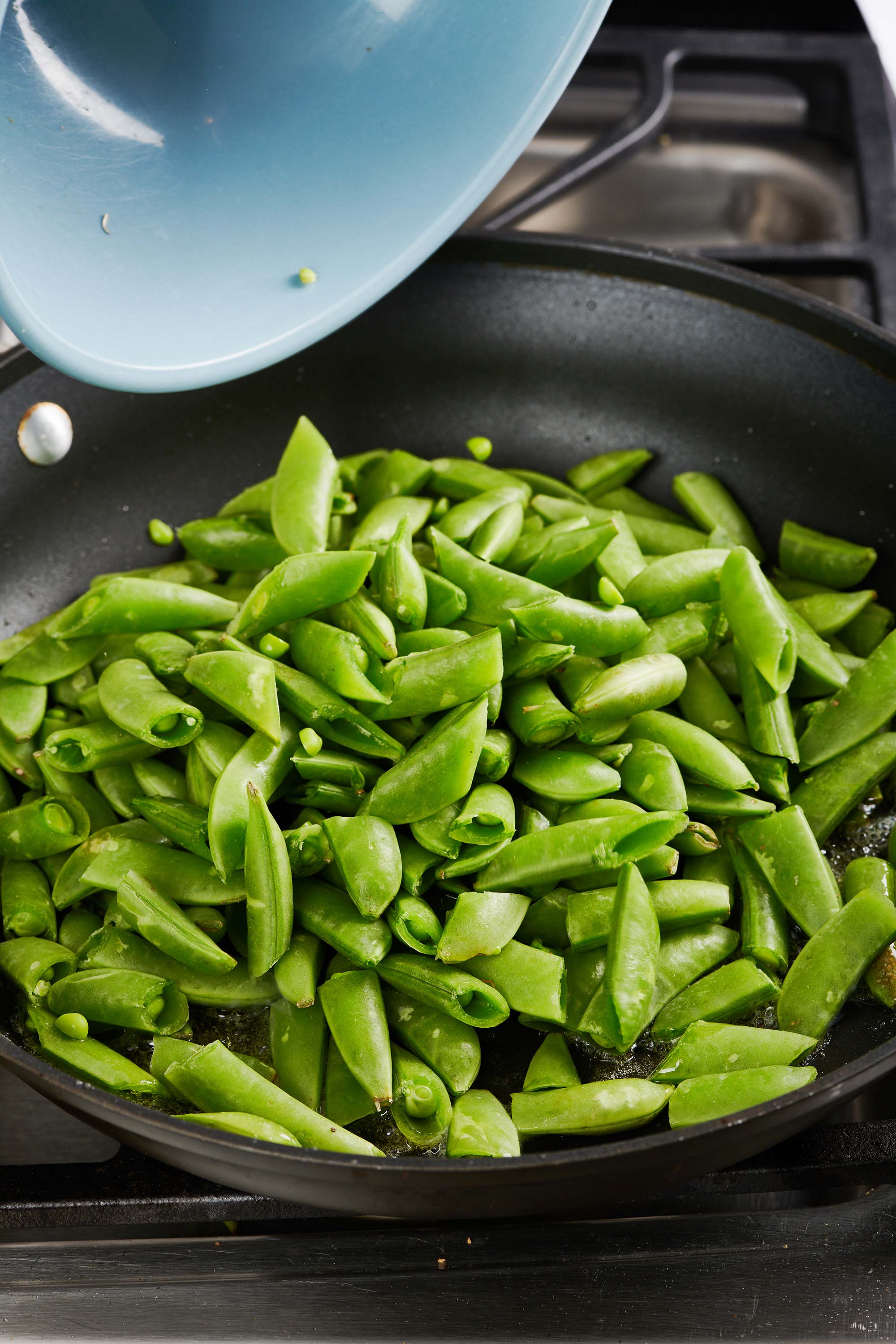 Sliced sugar snap peas in a pan.