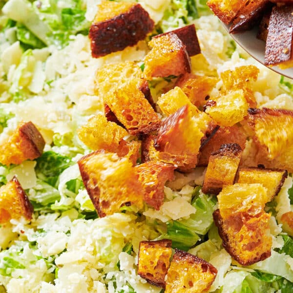 Homemade croutons on salad in bowl.