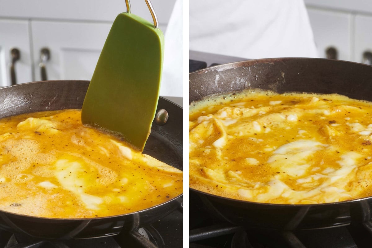 Eggs cooking in an omelet pan.