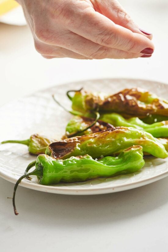 Cooked Shishito Peppers on a plate.