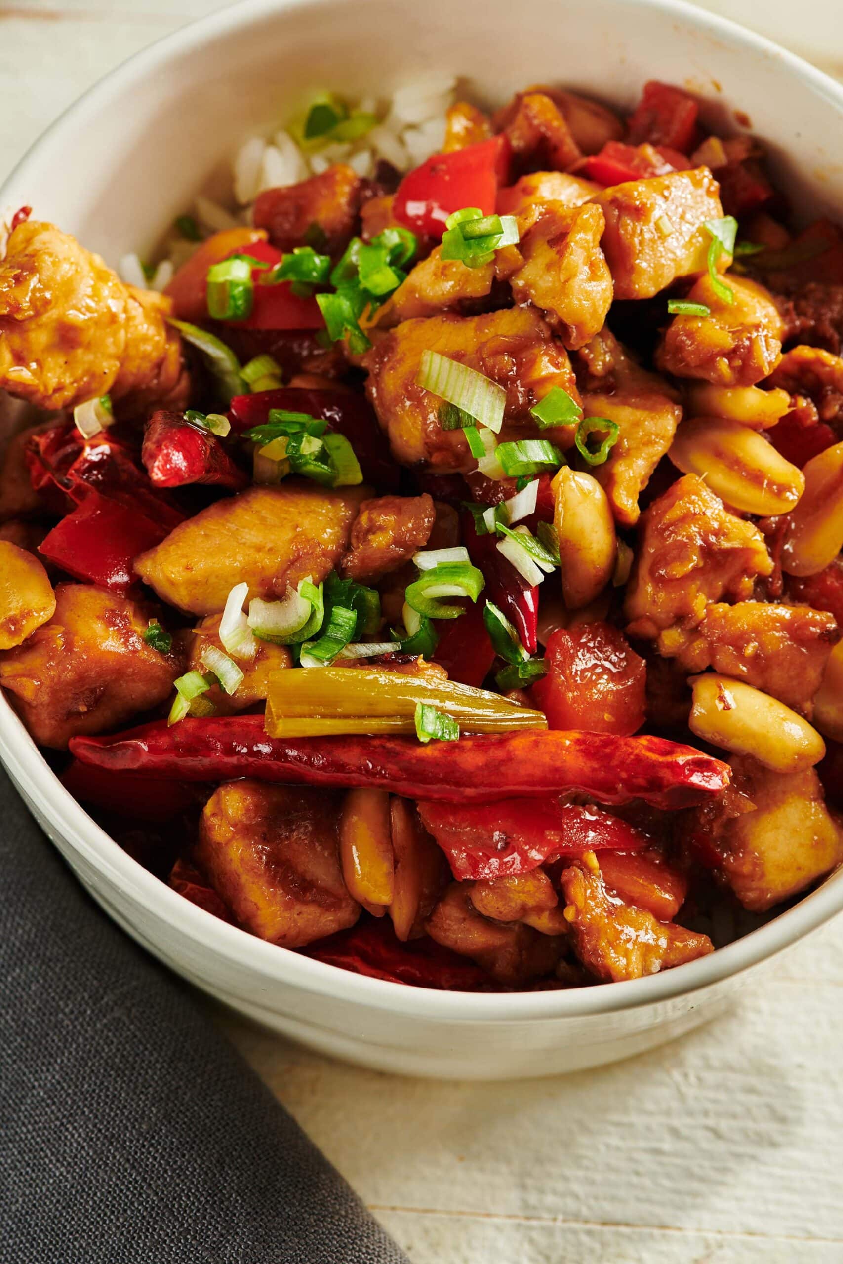 Bowl of Kung Pao Chicken on table.
