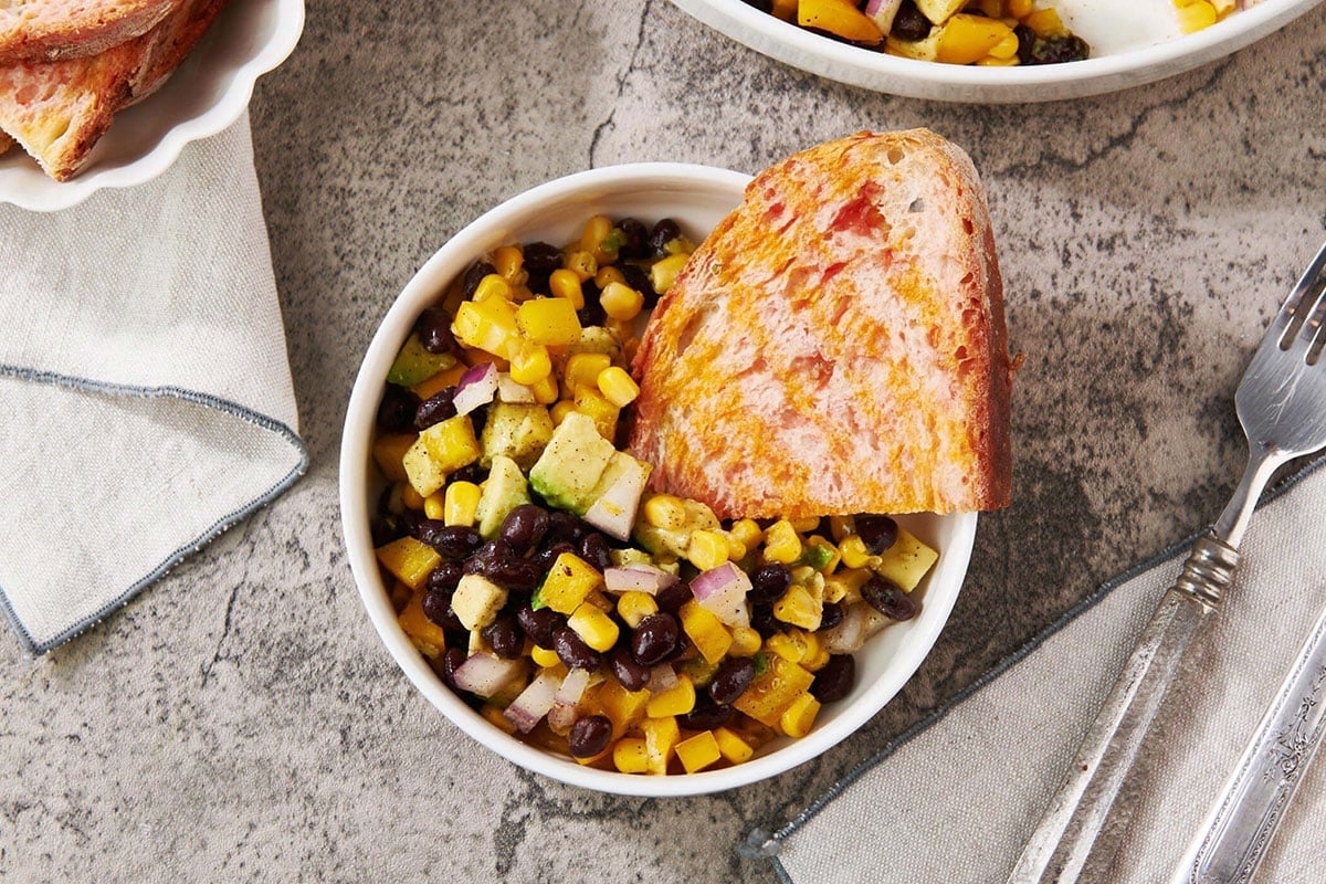 Southwest Black Bean and Corn Salad with Spanish Tomato Bread in bowl.