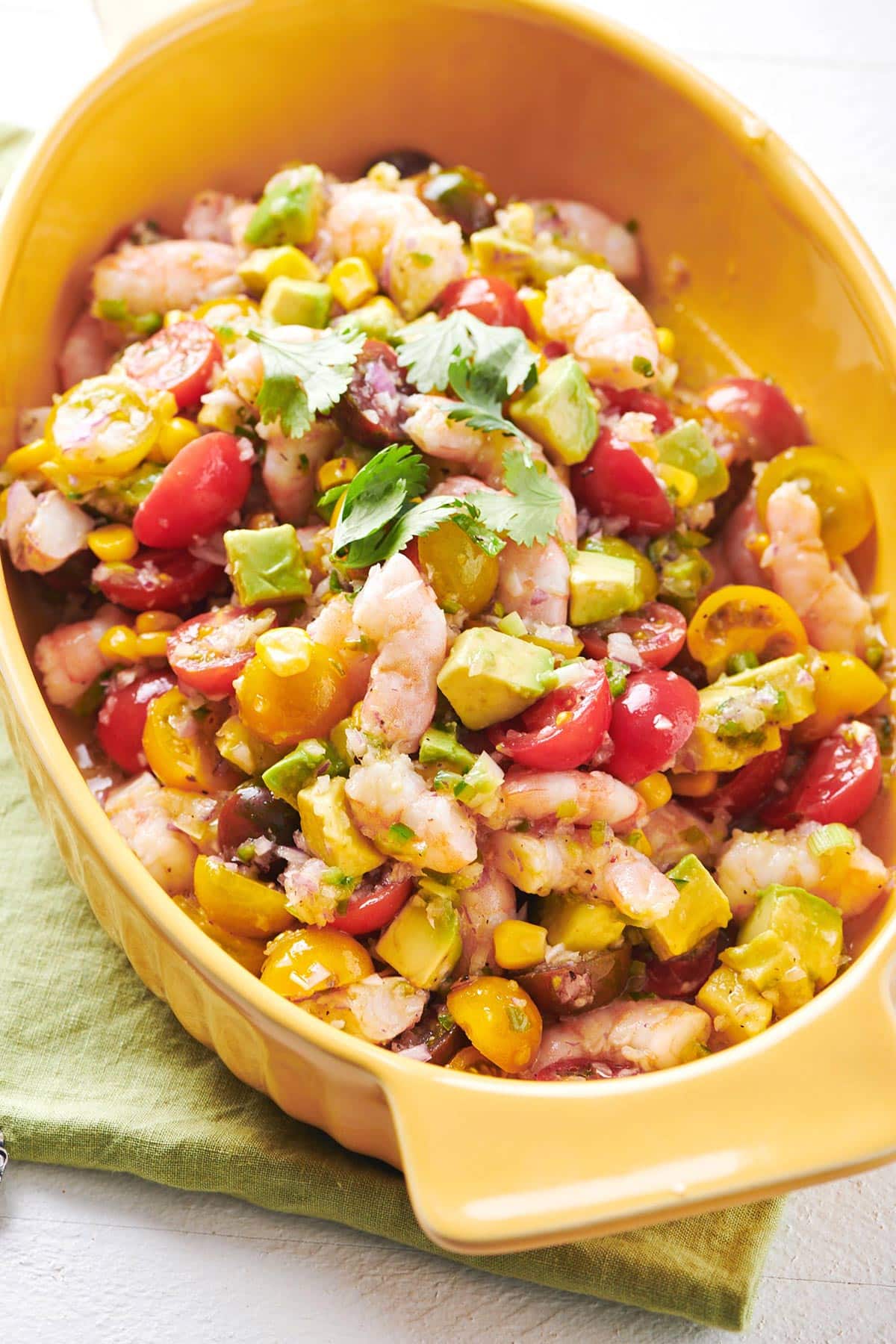 Orange dish of Shrimp and Avocado Salad.
