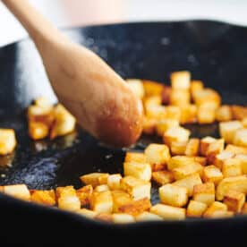 Cooking potatoes in cast iron pan.
