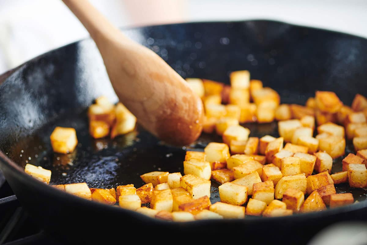 Cooking potatoes in cast iron pan.