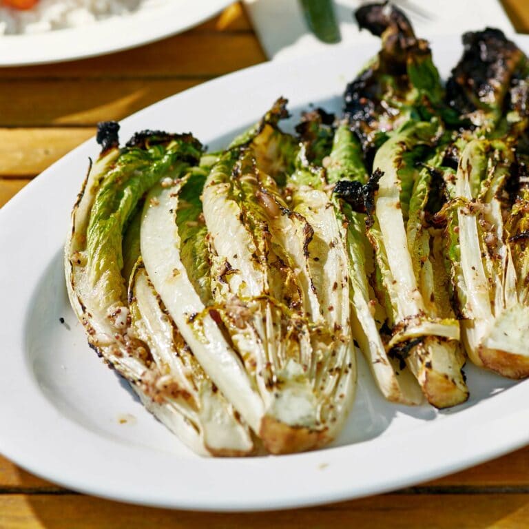 Grilled Romaine on a white dish.