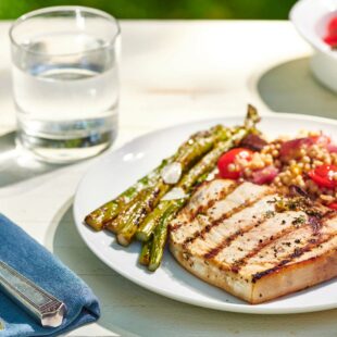 Grilled Swordfish on a plate with asparagus.