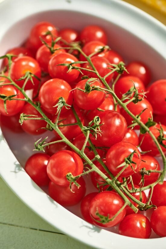 Bowl of fresh cherry tomatoes on the vine.