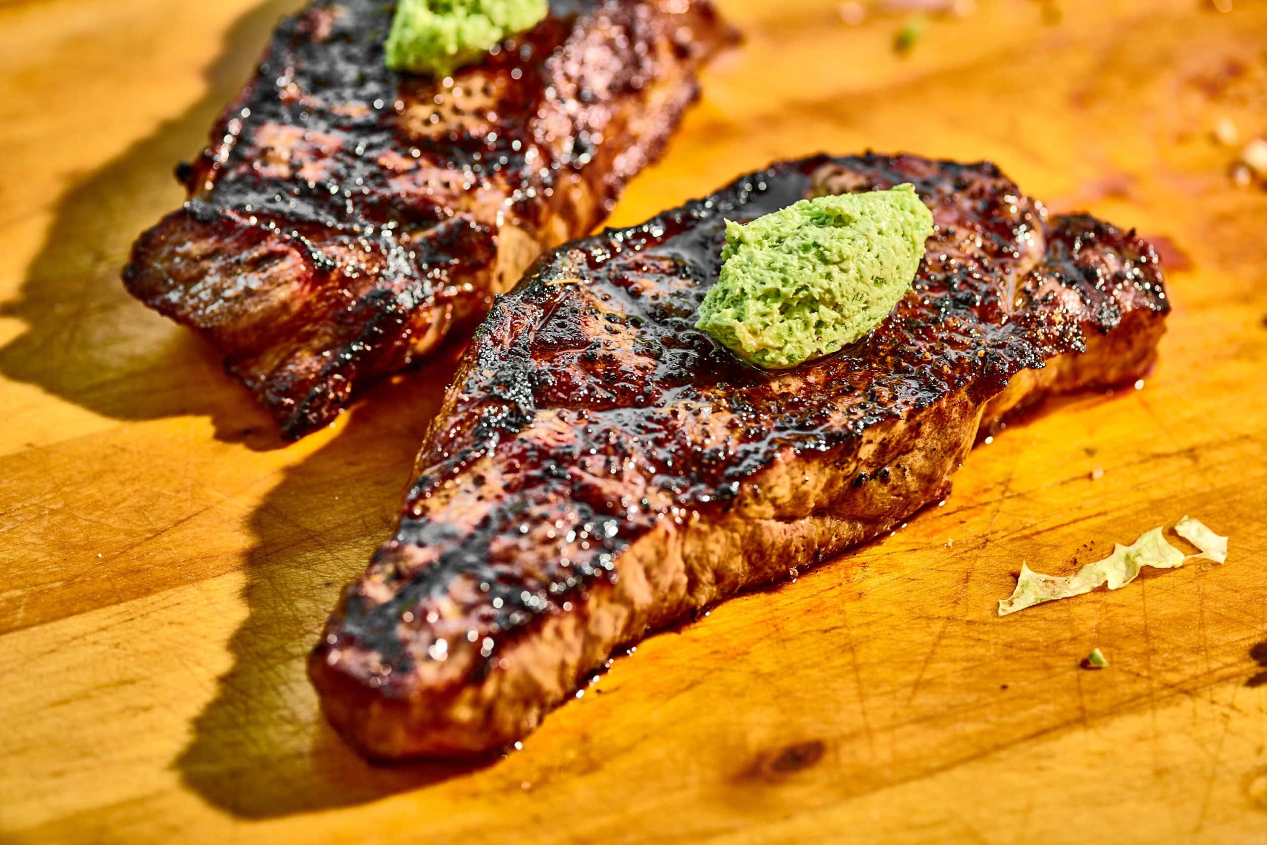 New York Strip Steak with Jalapeno Butter on cutting board.