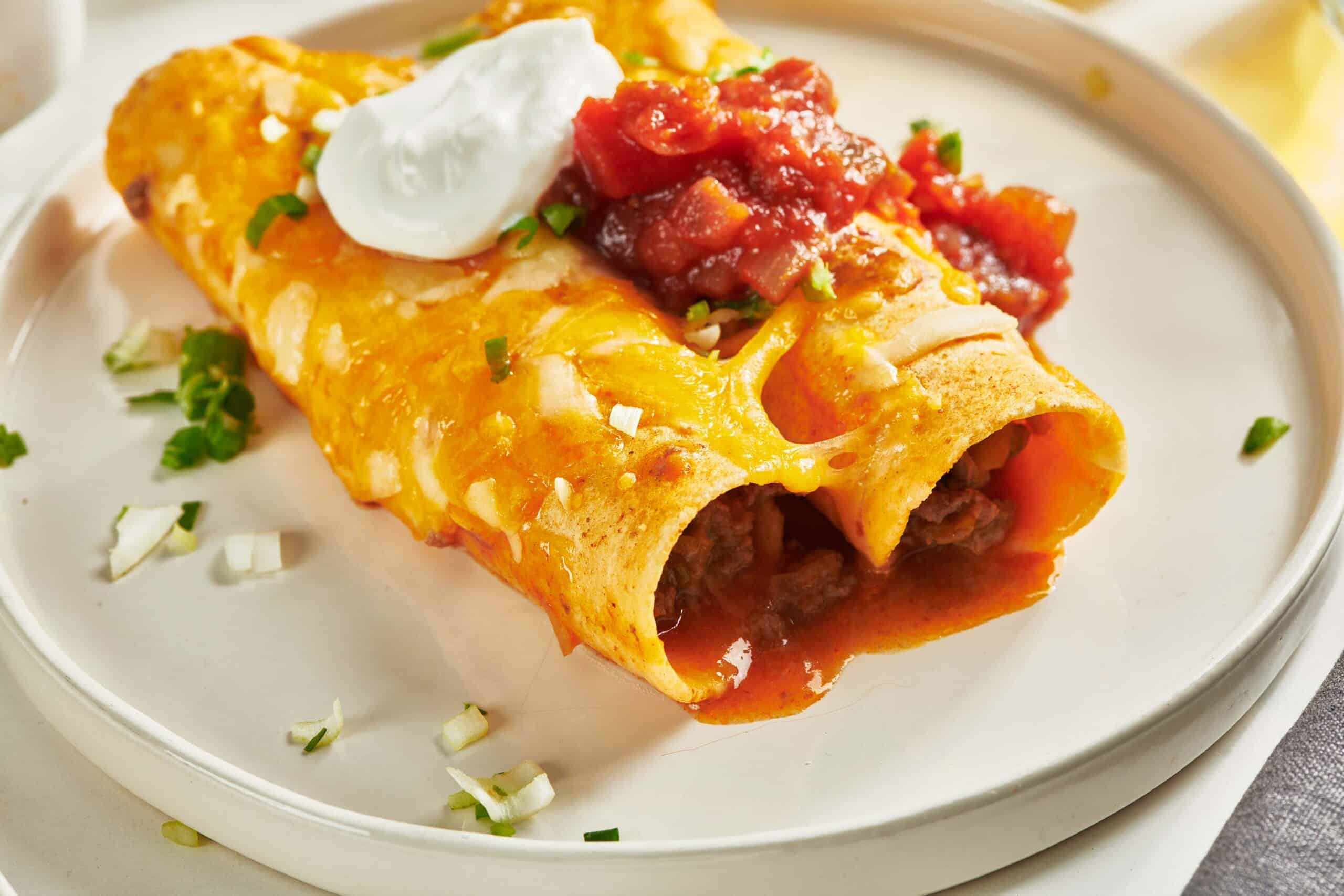 Ground Beef Enchiladas on white plate.