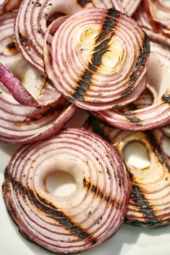 Sliced red onions with grill marks.