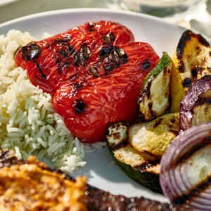 Grilled Vegetables on a plate with rice and meat.