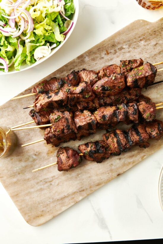 Moroccan-Inspired Lamb Kebabs on a wooden board.