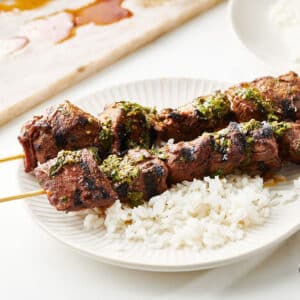 Skewered Moroccan-Inspired Lamb Kebabs on rice.