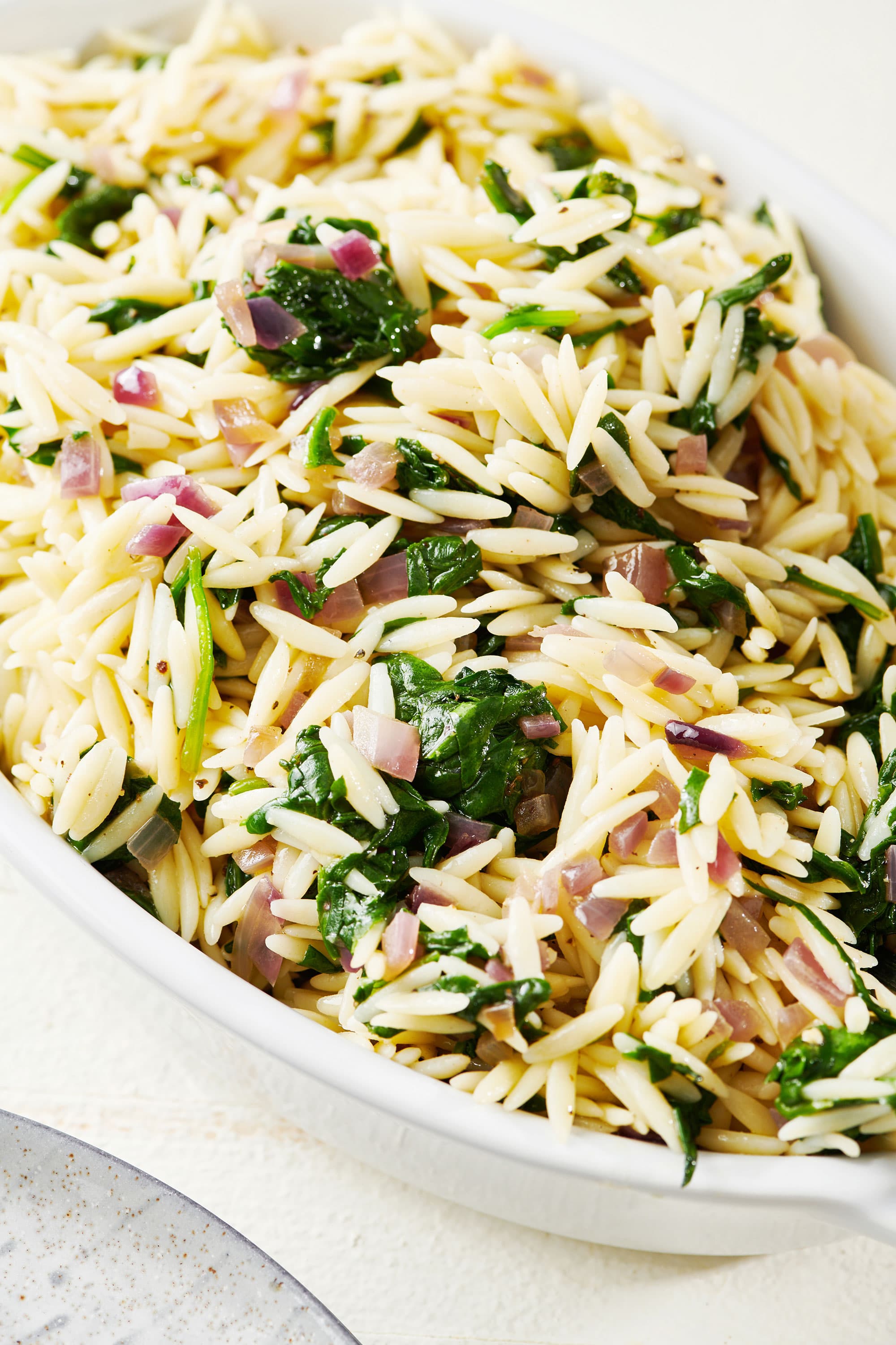 Spinach Orzo Salad in a white bowl.