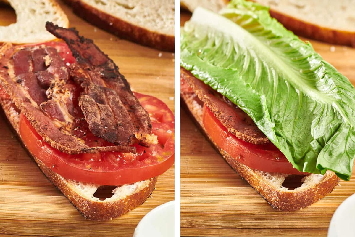 Adding bacon and lettuce to BLT sandwich on cutting board.