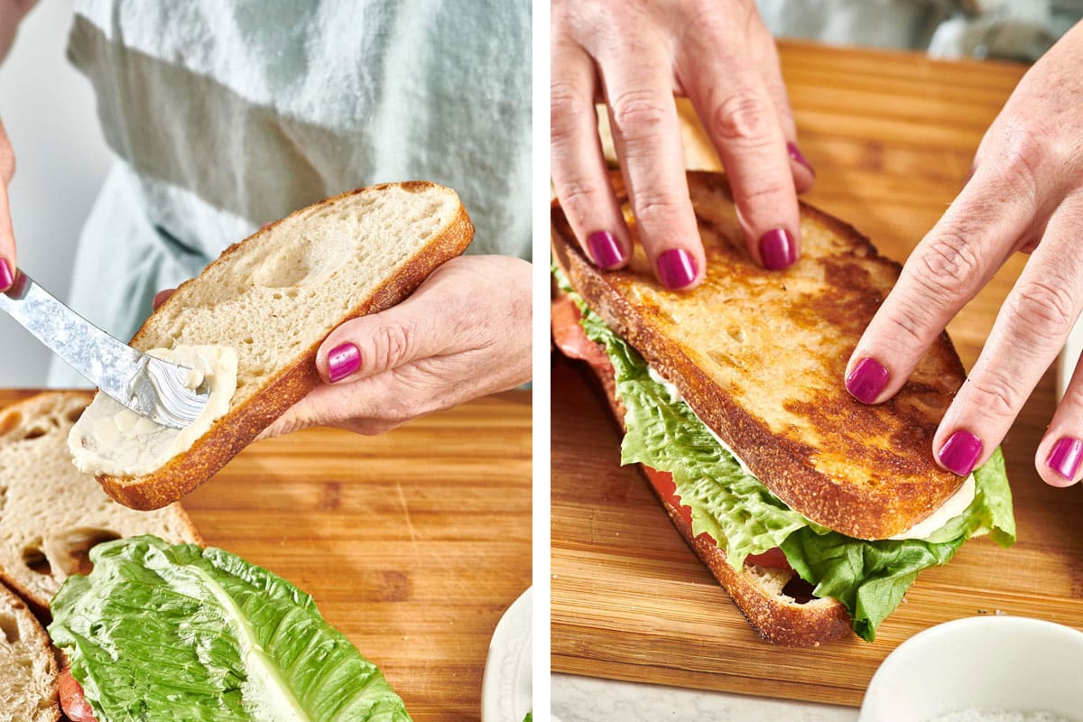 Woman spreading mayonnaise on bread and building a BLT sandwich.