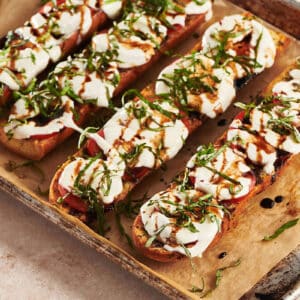 Caprese Garlic Bread on a lined baking sheet.