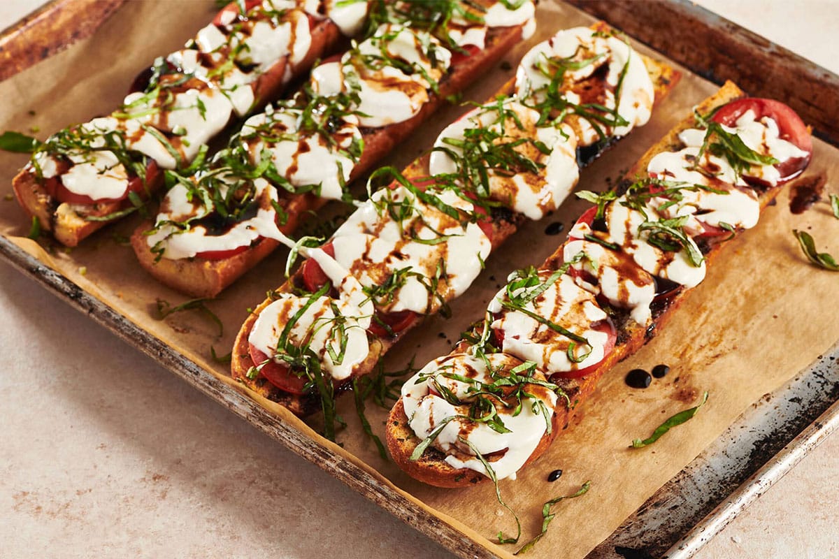 Caprese Garlic Bread on a lined baking sheet.