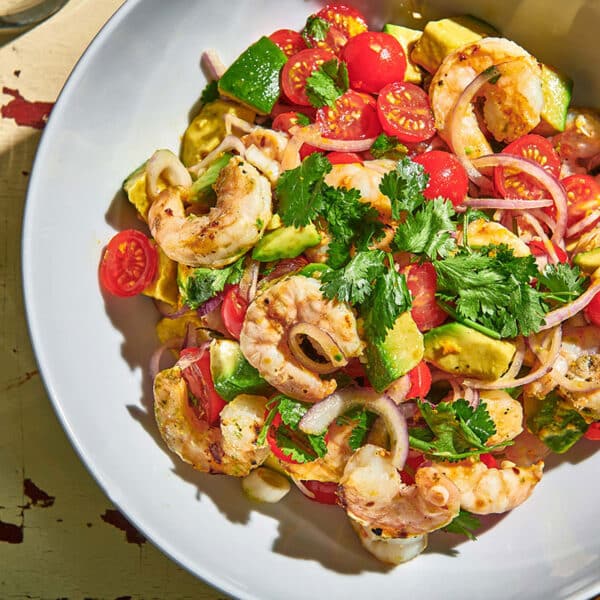 Grilled Shrimp Salad with Citrus Dressing in serving bowl on picnic table.
